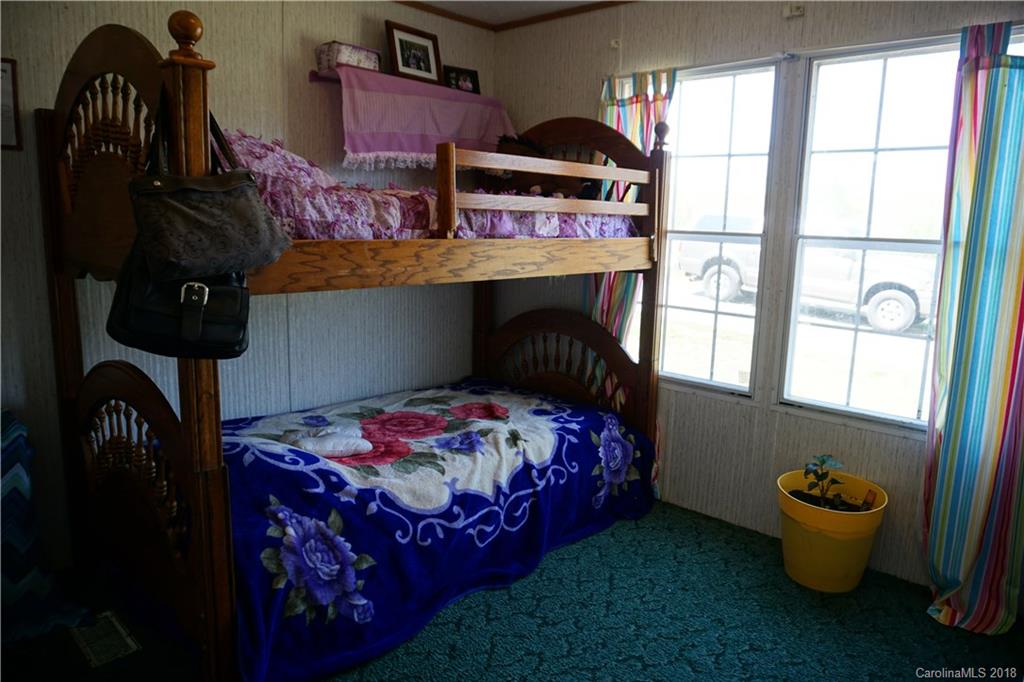 1042 Elliott Road Rutherfordton, NC 28139 - Photo 29 of 33 a bedroom with a bed and a window