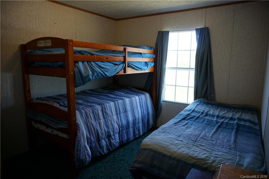 1042 Elliott Road Rutherfordton, NC 28139 - Photo 30 of 33 a bedroom with a bed and a window
