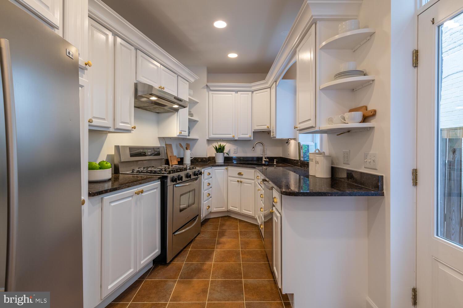 302 L Street Southeast Washington, DC 20003 - Photo 11 of 32 a kitchen with stainless steel appliances granite countertop a sink and cabinets