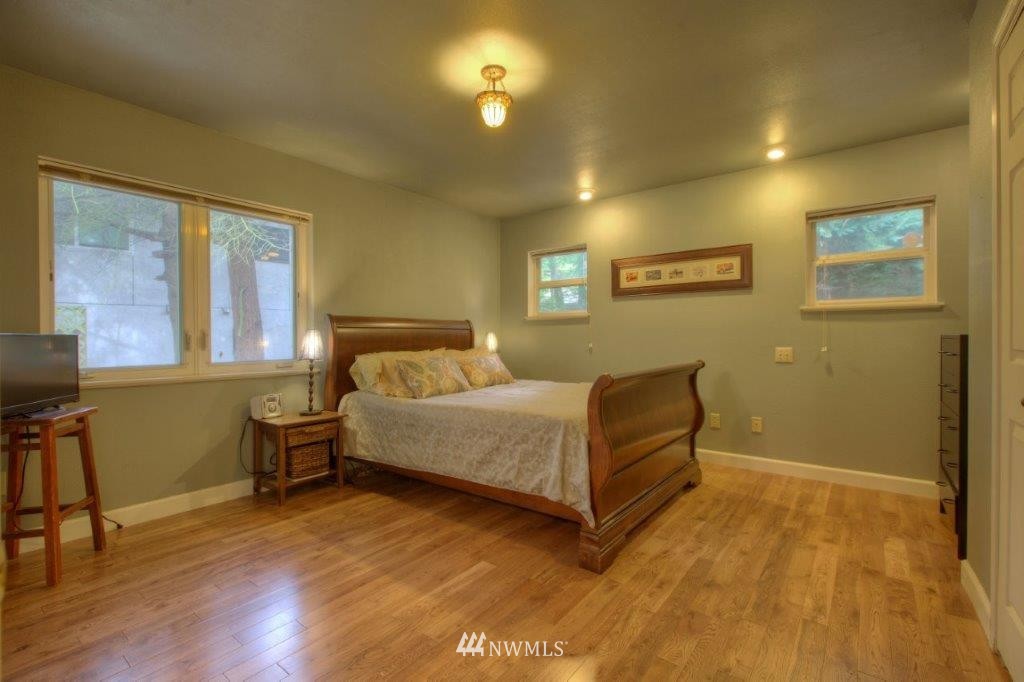 1114 Northeast 145th Street Shoreline, WA 98155 - Photo 12 of 19 a bedroom with a bed and a table in it