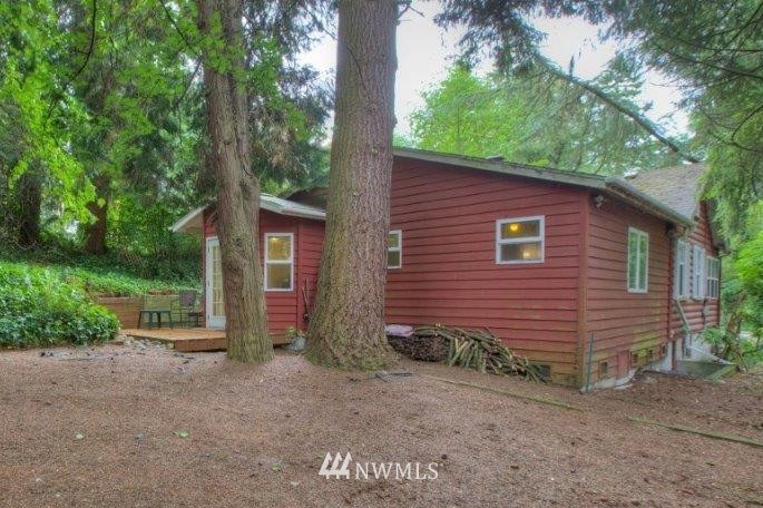 1114 Northeast 145th Street Shoreline, WA 98155 - Photo 18 of 19 a view of a backyard with potted plants and large tree