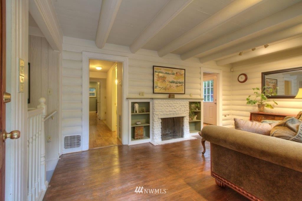 1114 Northeast 145th Street Shoreline, WA 98155 - Photo 3 of 19 a living room with furniture and a fireplace