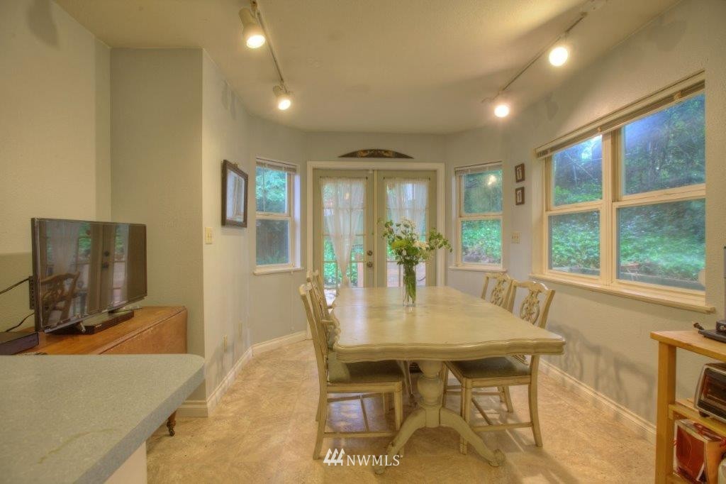 1114 Northeast 145th Street Shoreline, WA 98155 - Photo 9 of 19 a view of a dining room with furniture and a window