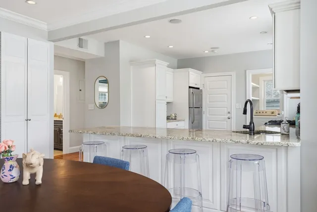 a dining room with furniture and wooden floor