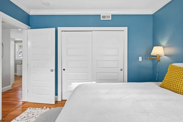 a bedroom with a bed and a potted plant