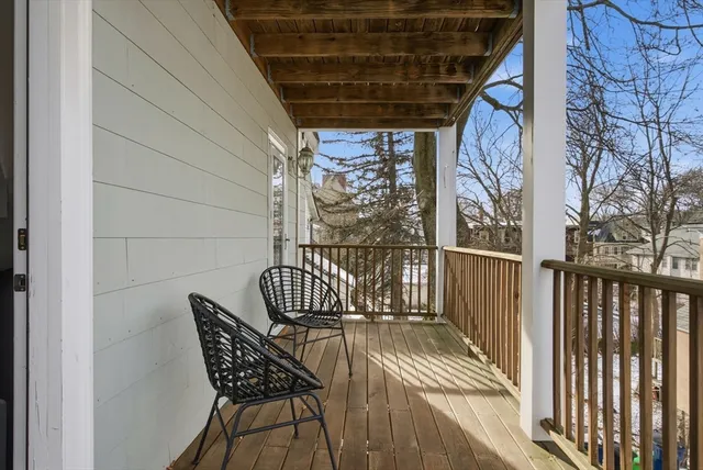 a view of a house with large windows and a table and chairs