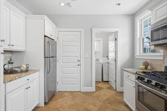 a kitchen with a stove and a refrigerator