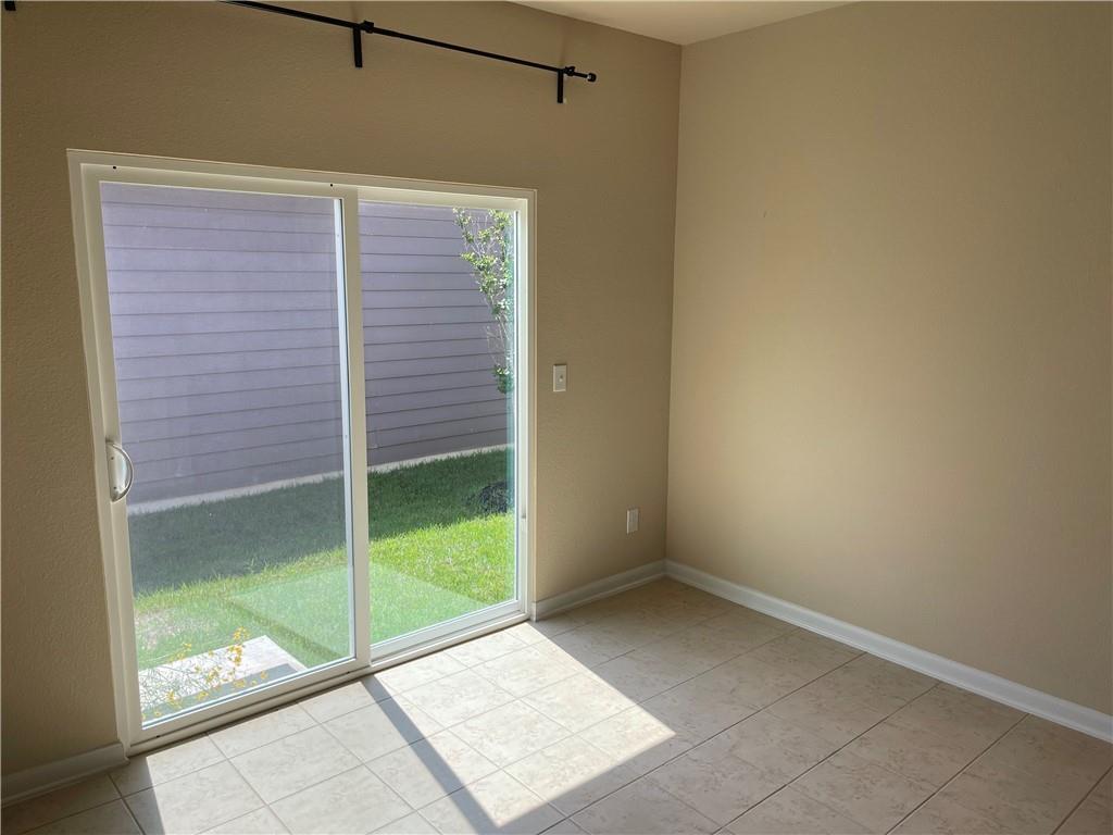 1420 Nevarez Kyle, TX 78640 - Photo 5 of 9 Sliding glass doors offer access to the yard from this inviting interior space.