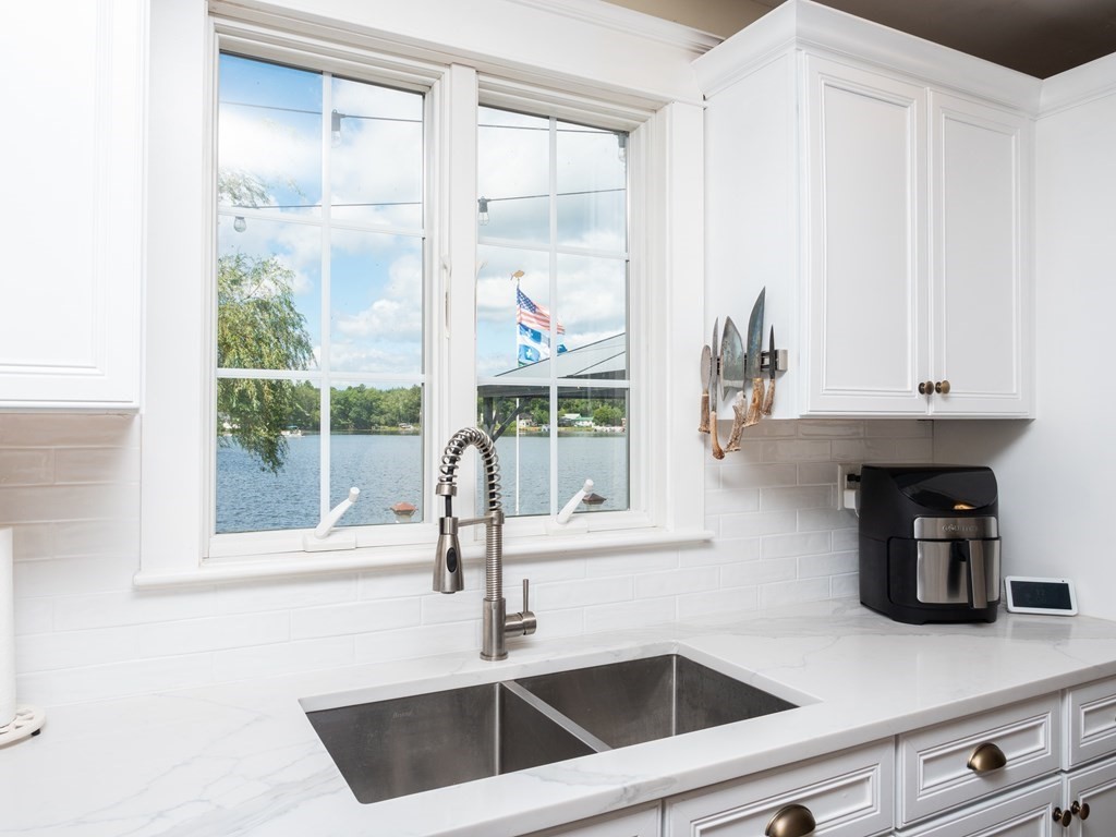 740 Reed Road Dartmouth, MA 02747 - Photo 13 of 26 a kitchen with a sink a window and cabinets