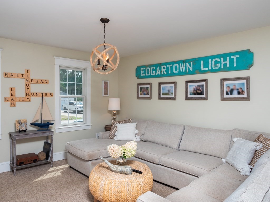 740 Reed Road Dartmouth, MA 02747 - Photo 17 of 26 a living room with furniture chandelier and a window