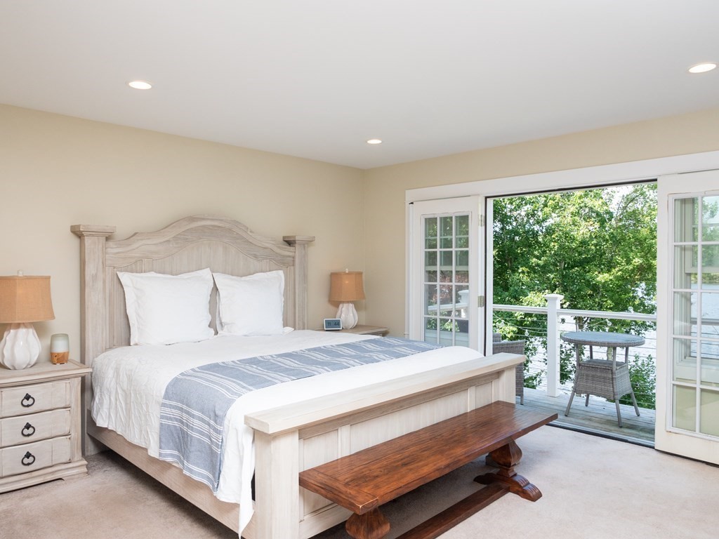 740 Reed Road Dartmouth, MA 02747 - Photo 18 of 26 a bedroom with a bed and a floor to ceiling window