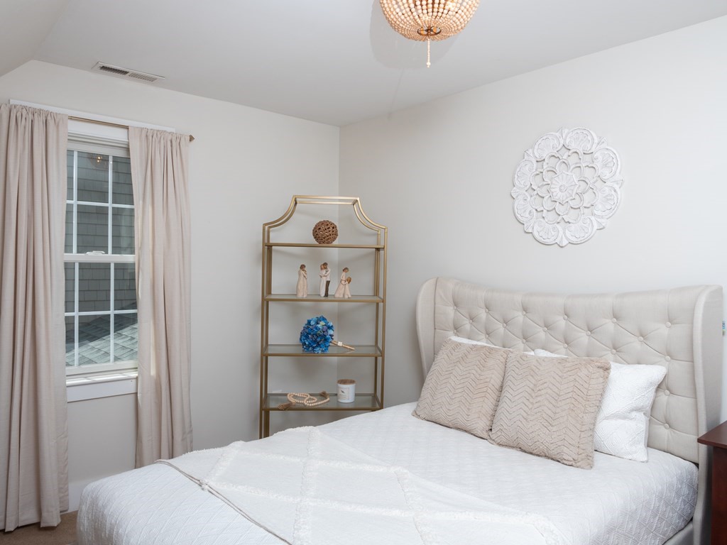 740 Reed Road Dartmouth, MA 02747 - Photo 24 of 26 a bedroom with a bed and a window