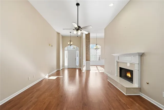 a hallway with a chandelier and wooden floor