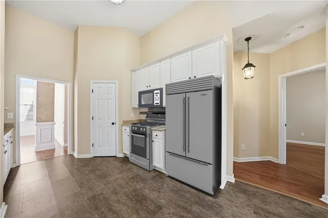 a kitchen with a sink a stove and cabinets