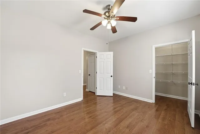 a view of an empty room with a fireplace and large windows