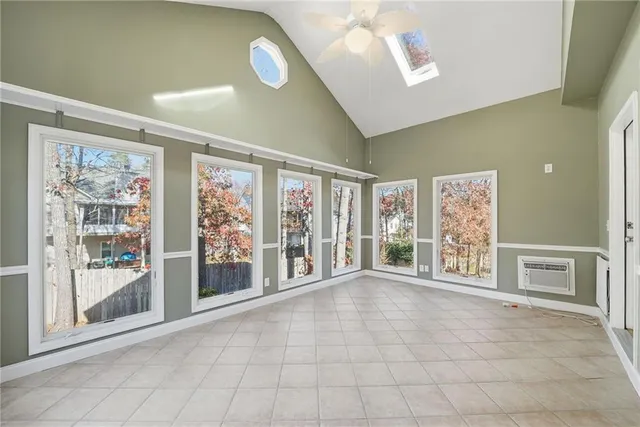 a view of a room with wooden floor and a ceiling fan