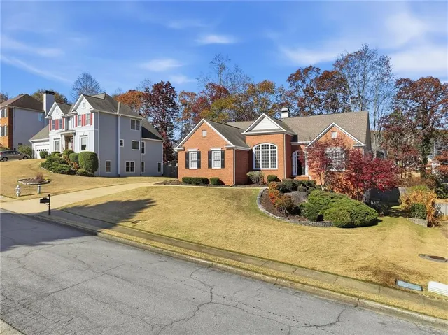 a view of residential houses with cars parked infront