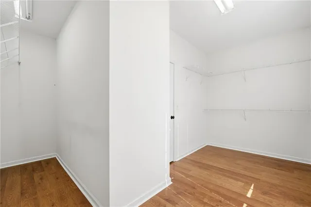 a view of a room with furniture and wooden floor