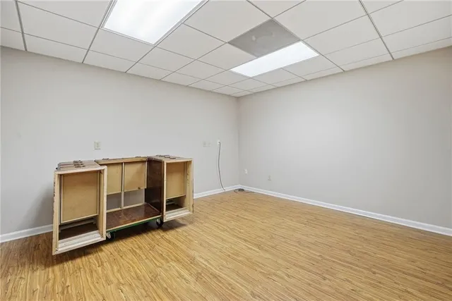 a view of a room with wooden floor lounge chair and a table