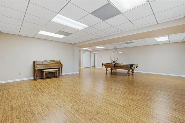a dining room with furniture and large windows