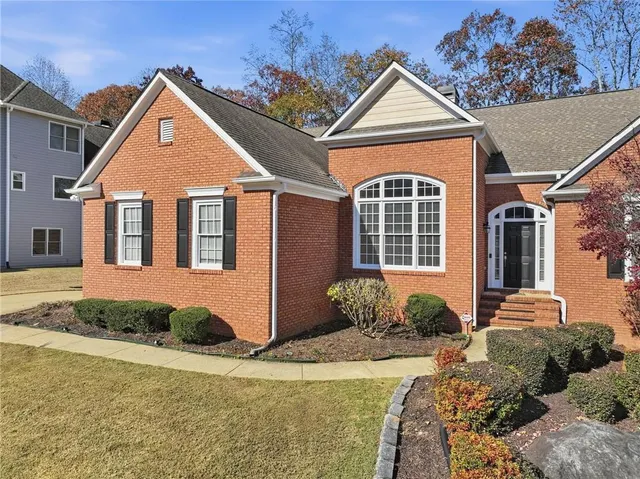 a front view of a house with garden