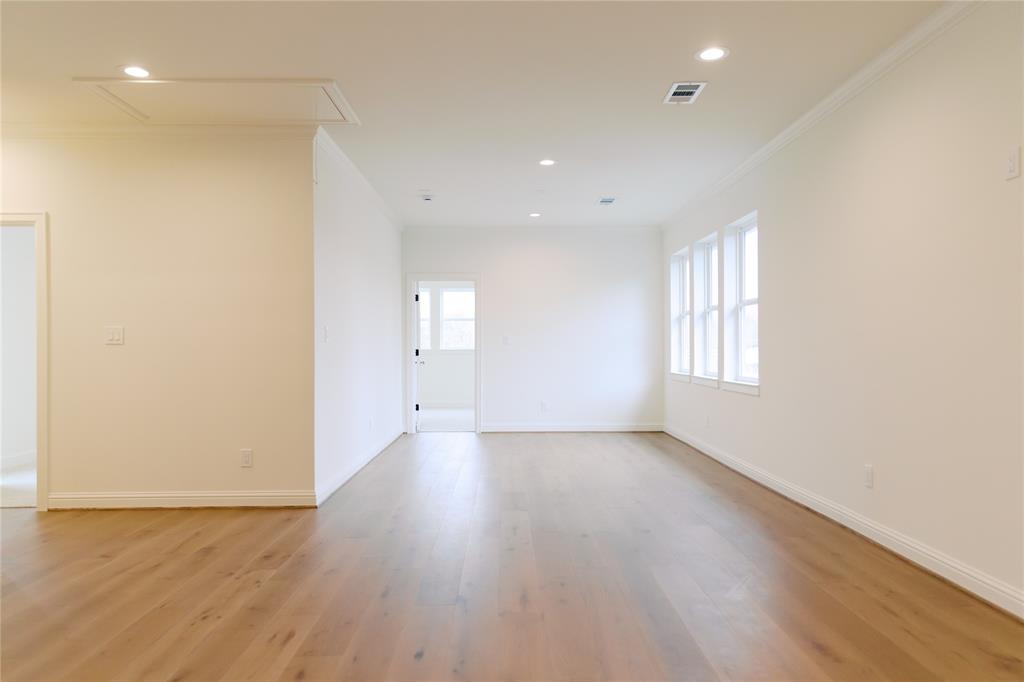 10930 Beauty Lane Dallas, TX 75229 - Photo 11 of 27 an empty room with wooden floor and windows