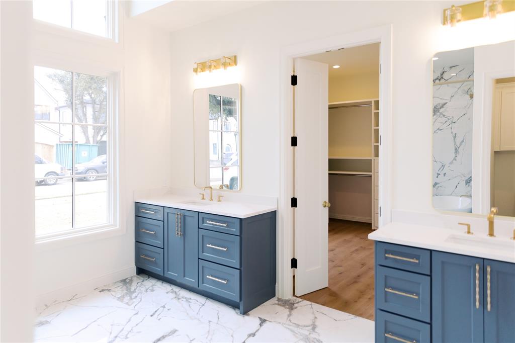 10930 Beauty Lane Dallas, TX 75229 - Photo 18 of 27 a bathroom with a vanity mirror and a sink