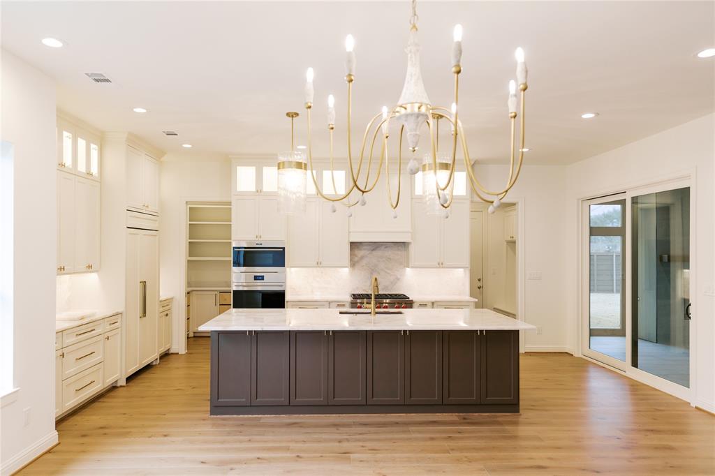 10930 Beauty Lane Dallas, TX 75229 - Photo 5 of 27 a large room with lots of counter space and wooden floor