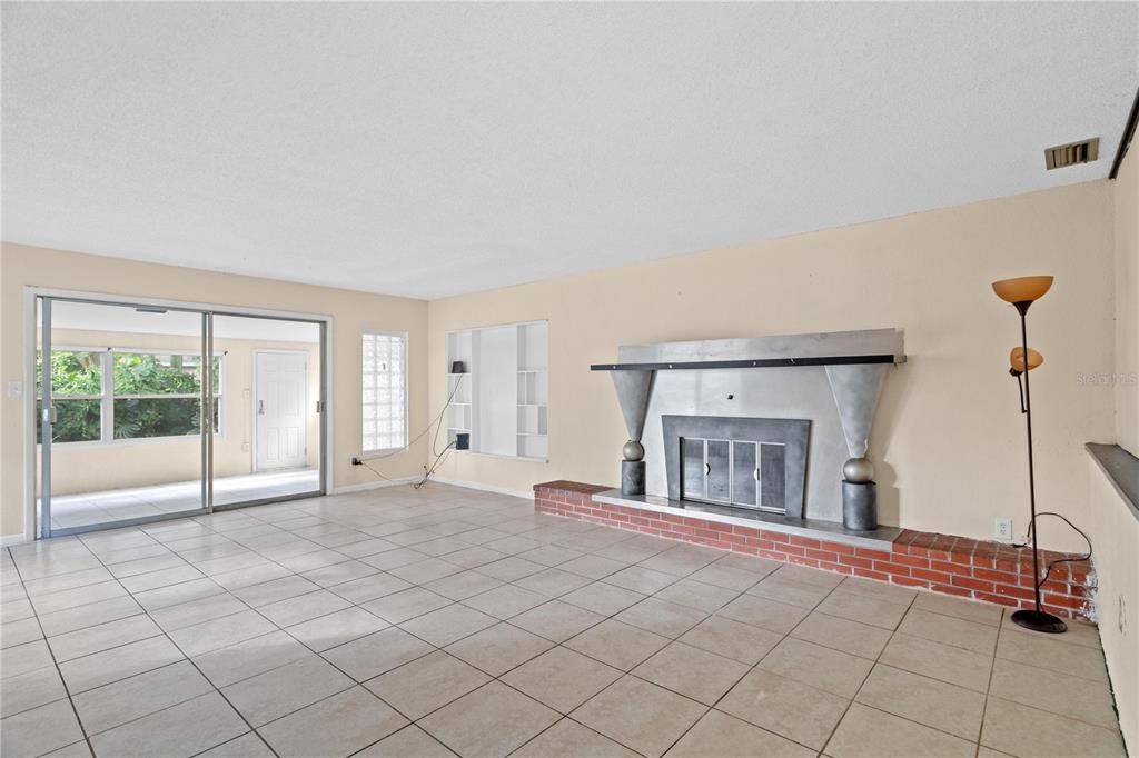 10 Kepner Street Orlando, FL 32839 - Photo 11 of 26 a view of an empty room with a fireplace and a large window