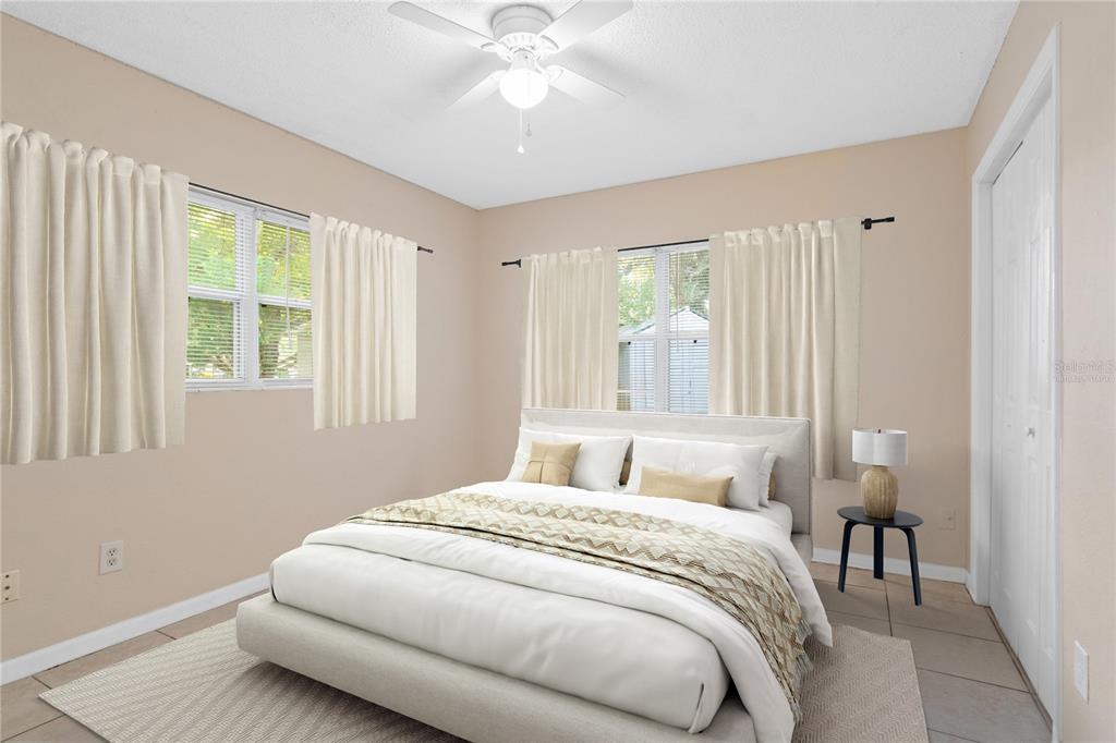 10 Kepner Street Orlando, FL 32839 - Photo 17 of 26 a bedroom with a large bed and a chandelier