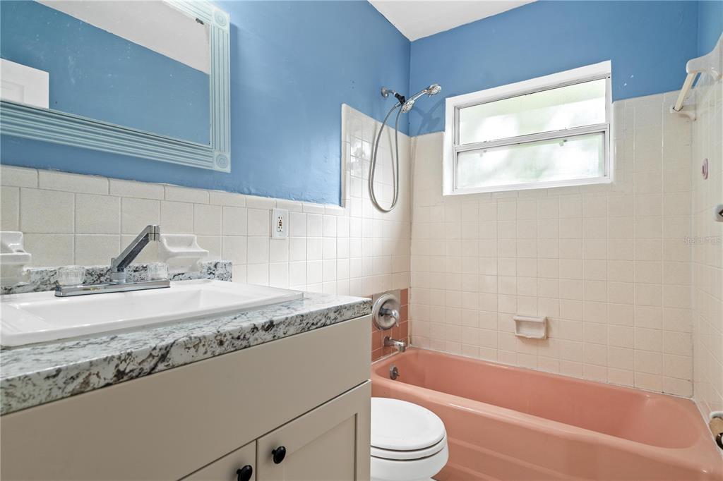 10 Kepner Street Orlando, FL 32839 - Photo 18 of 26 a bathroom with a granite countertop sink toilet and bathtub