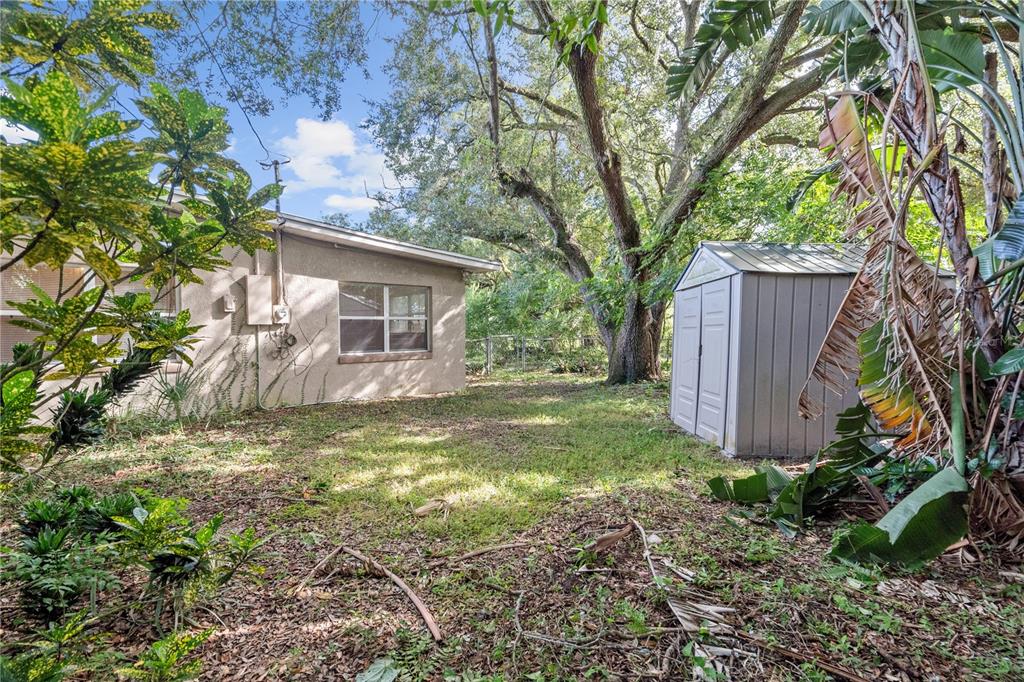 10 Kepner Street Orlando, FL 32839 - Photo 23 of 26 a view of a house with backyard and trees