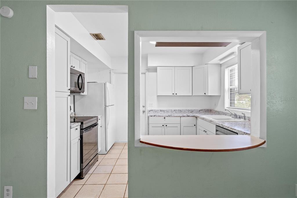 10 Kepner Street Orlando, FL 32839 - Photo 6 of 26 a kitchen with stainless steel appliances granite countertop a sink and a refrigerator