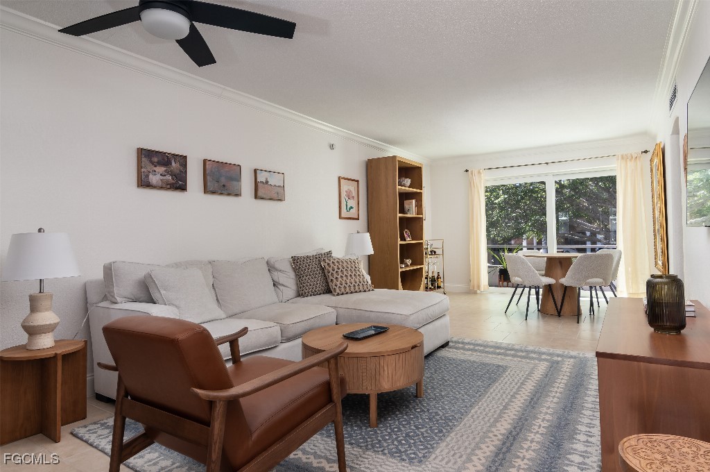 72 7th Street South, Unit 206 Naples, FL 34102 - Photo 2 of 10 a living room with furniture and a large window