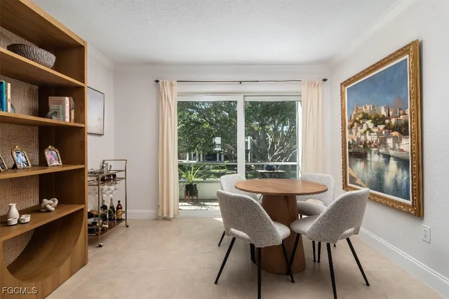 a dining room with furniture and a window
