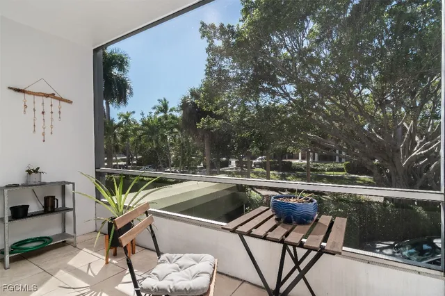 a view of a chairs and table in the balcony