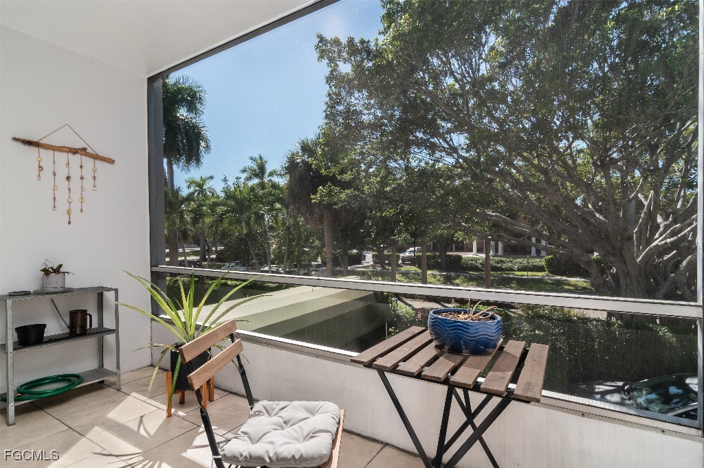 72 7th Street South, Unit 206 Naples, FL 34102 - Photo 5 of 10 a view of a chairs and table in the balcony