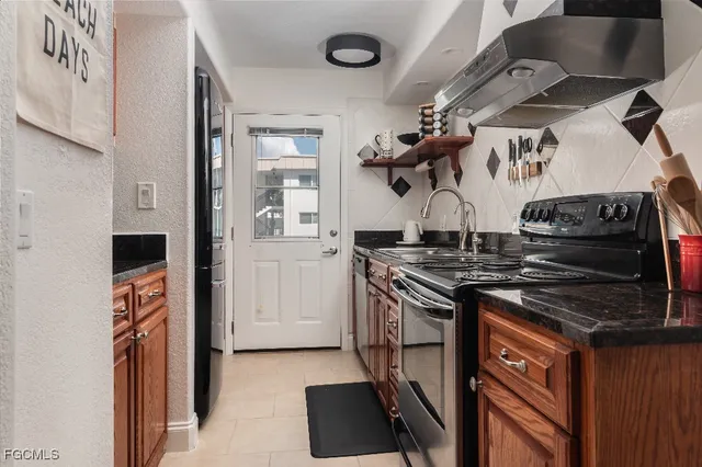a kitchen with stainless steel appliances granite countertop a stove and a refrigerator
