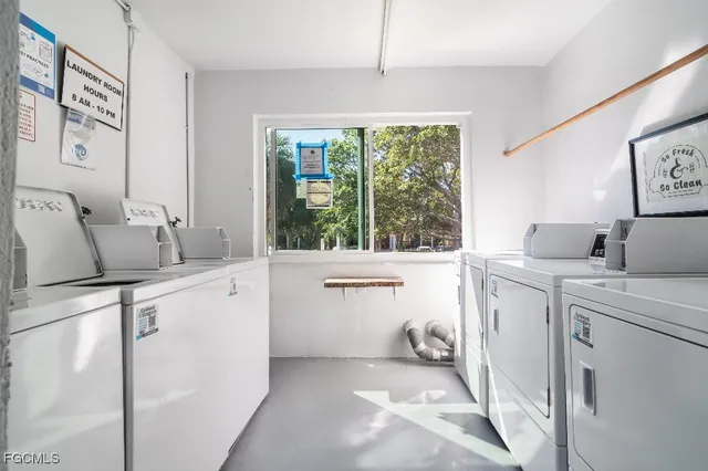 a room with sink dryer and washer