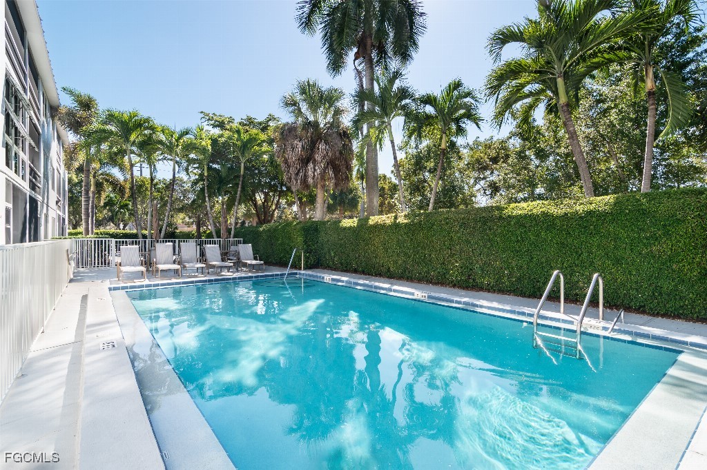 72 7th Street South, Unit 206 Naples, FL 34102 - Photo 10 of 10 a view of a swimming pool with a garden