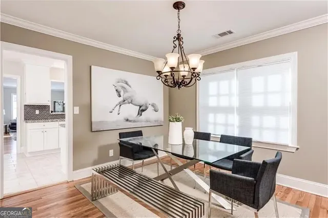 a living room with furniture a chandelier and a table