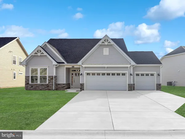 a view of a house with a big yard and large trees