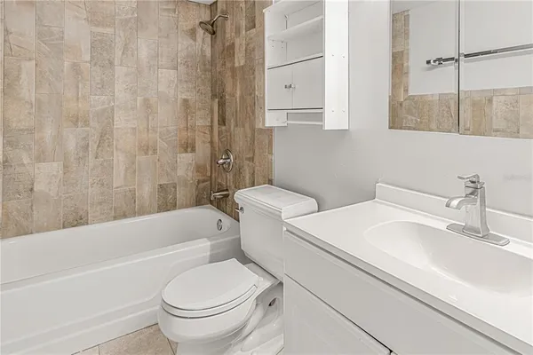 a bathroom with a sink a toilet and a bathtub
