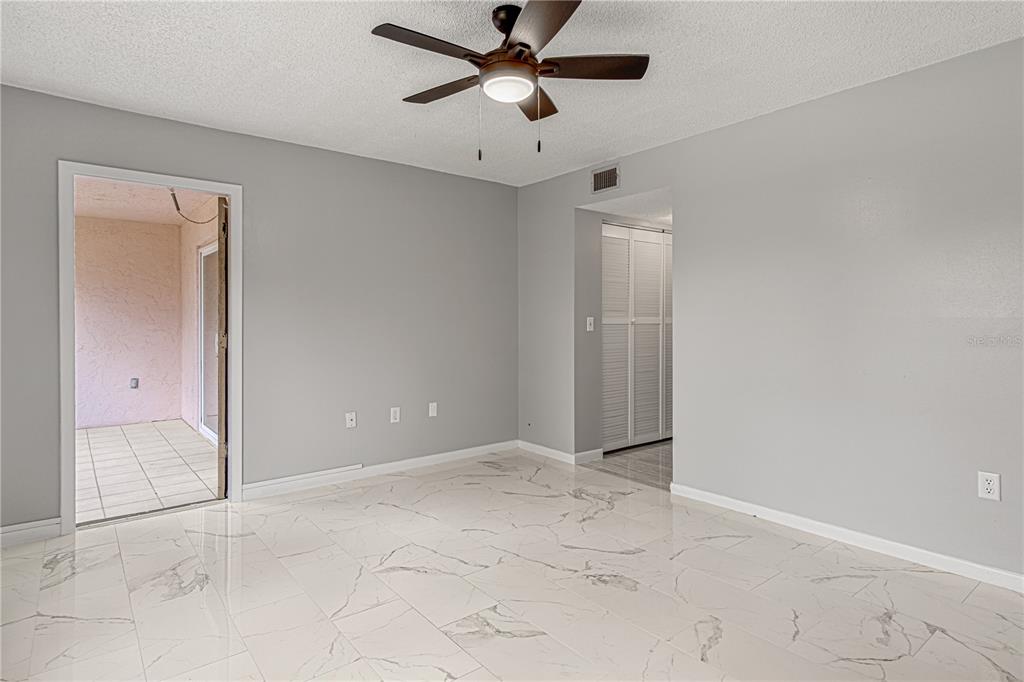 640 North Nova Road, Unit 409 Ormond Beach, FL 32174 - Photo 16 of 33 a view of an empty room and chandelier fan