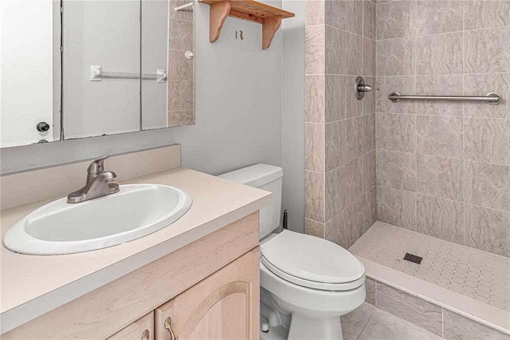 640 North Nova Road, Unit 409 Ormond Beach, FL 32174 - Photo 17 of 33 a bathroom with a sink a toilet and shower