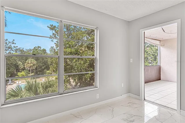 a view of a room with a large window and front door