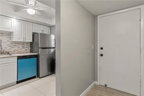 a kitchen with a refrigerator and a sink