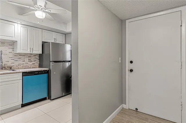 a kitchen with a refrigerator and a sink
