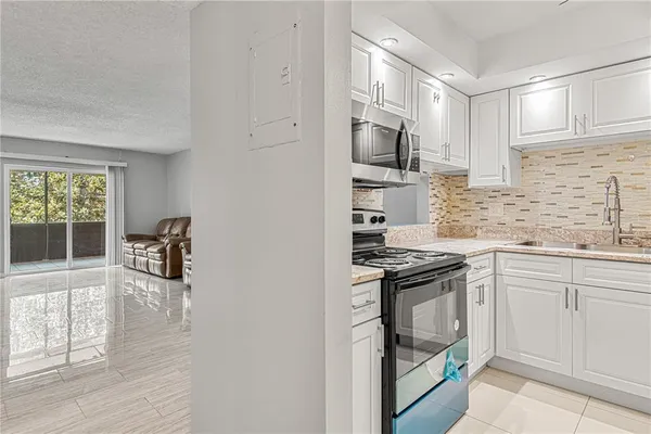 a kitchen with granite countertop a stove and a sink