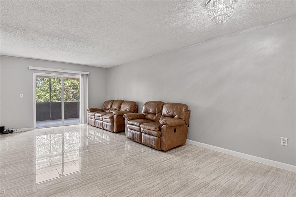 640 North Nova Road, Unit 409 Ormond Beach, FL 32174 - Photo 9 of 33 a living room with furniture and a window
